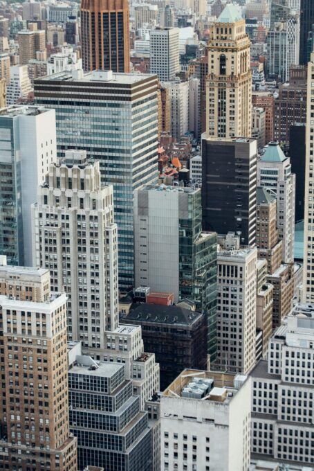 High angle view of a dense urban cityscape filled with tall commercial skyscrapers and varied architecture