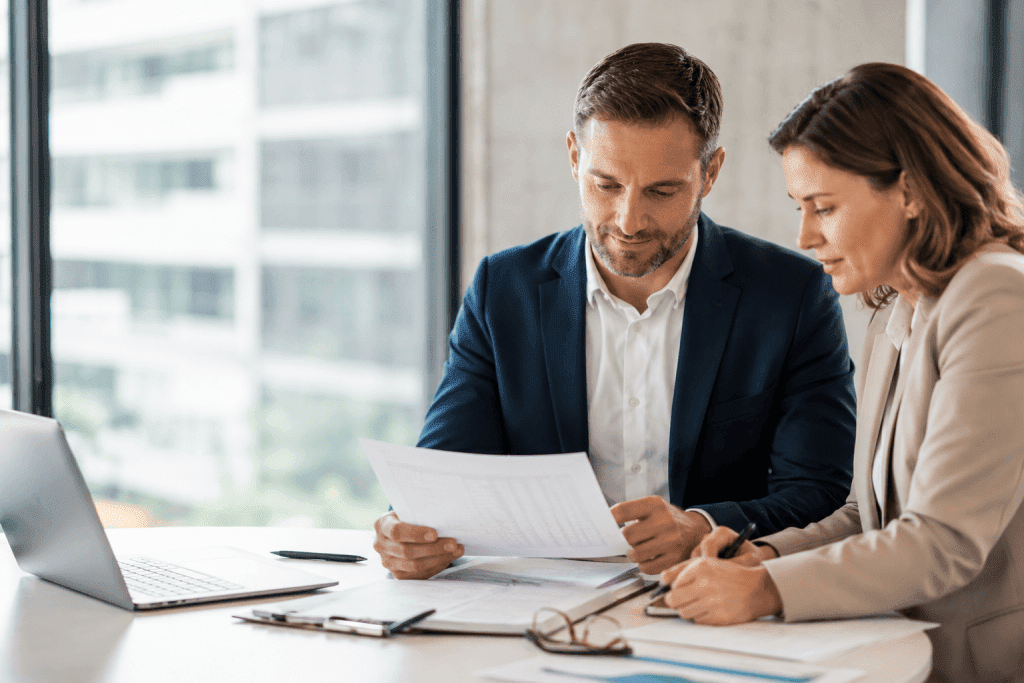 Financial consultants reviewing accounts receivable reports