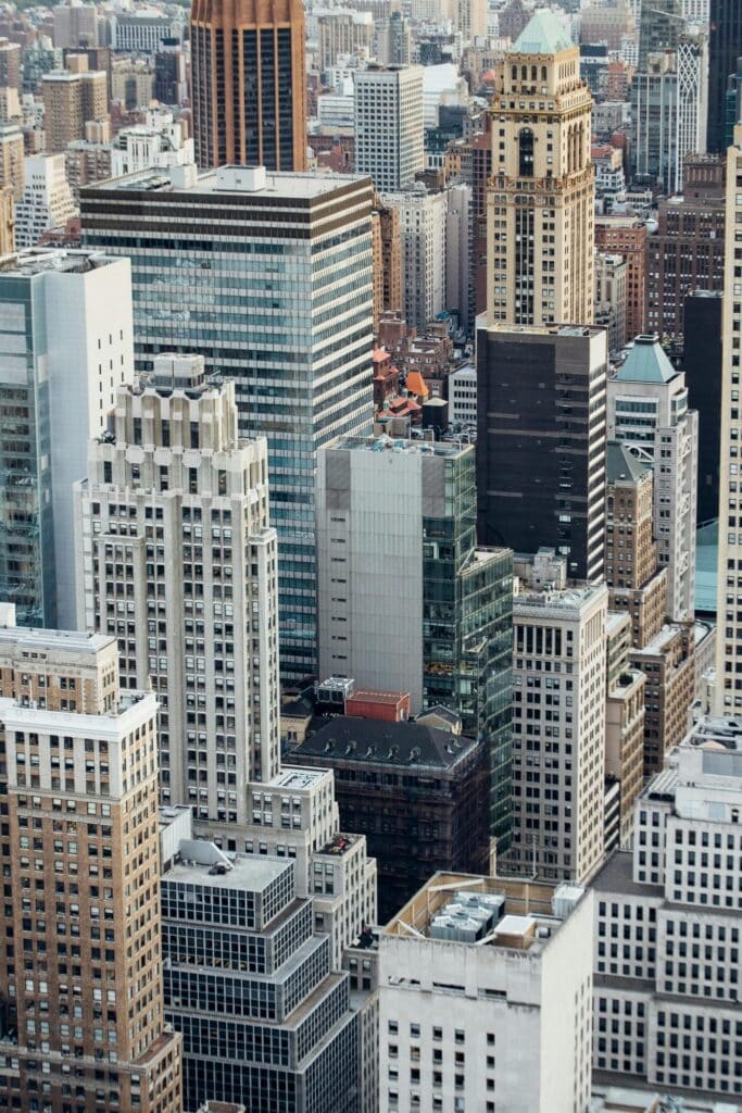 High angle view of a dense urban cityscape filled with tall commercial skyscrapers and varied architecture
